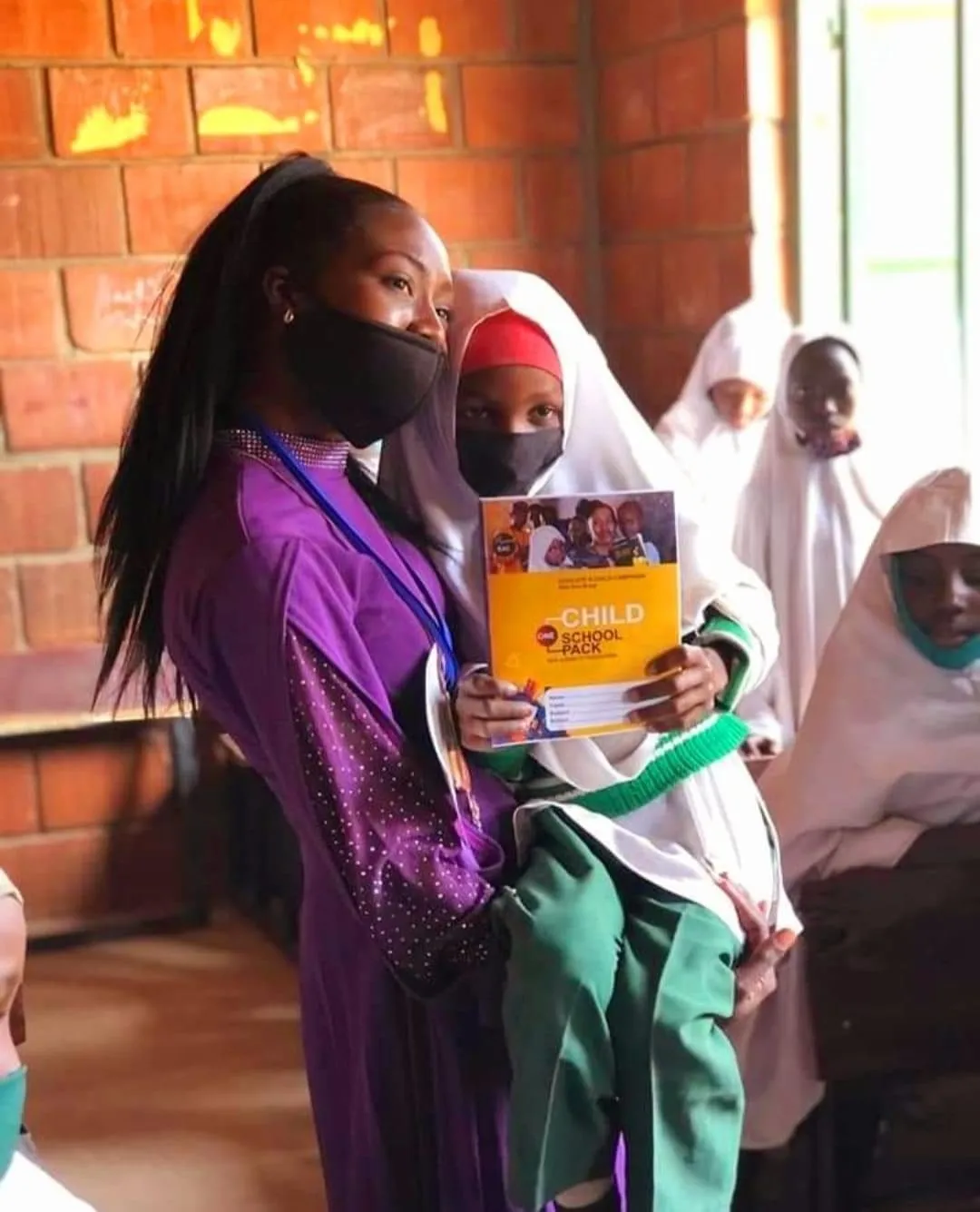 Seyi+and+a+Girl+at+EAC+Outreach-1